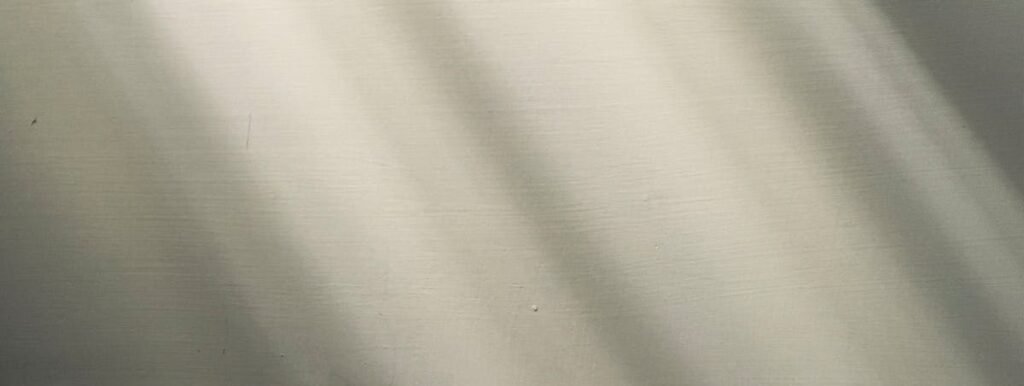 A minimalist wall featuring natural light casting soft shadows, creating a serene ambiance.